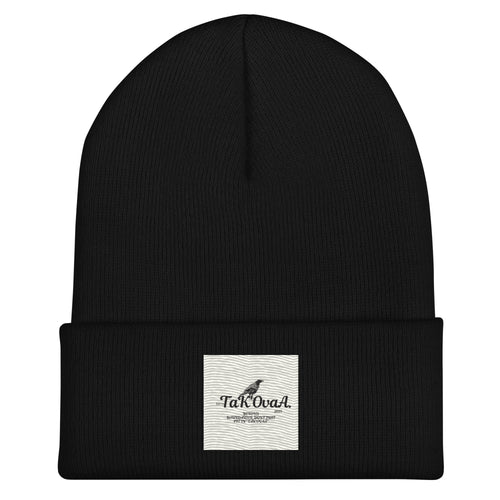 Black beanie with a white label on a white background