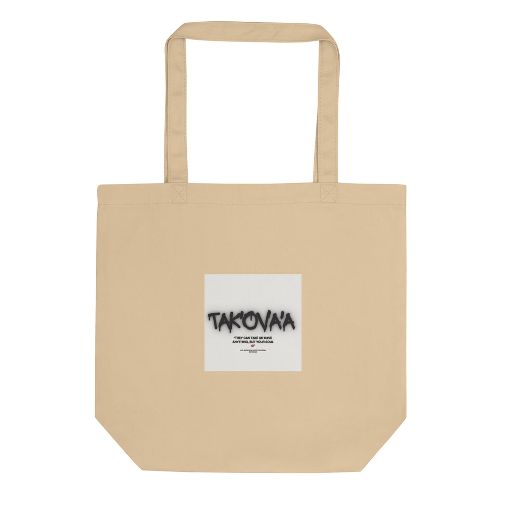 Beige tote bag with a white label featuring 'Takovaa' on a white background