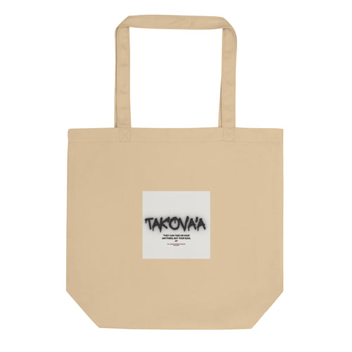 Beige tote bag with a white label featuring 'Takovaa' on a white background