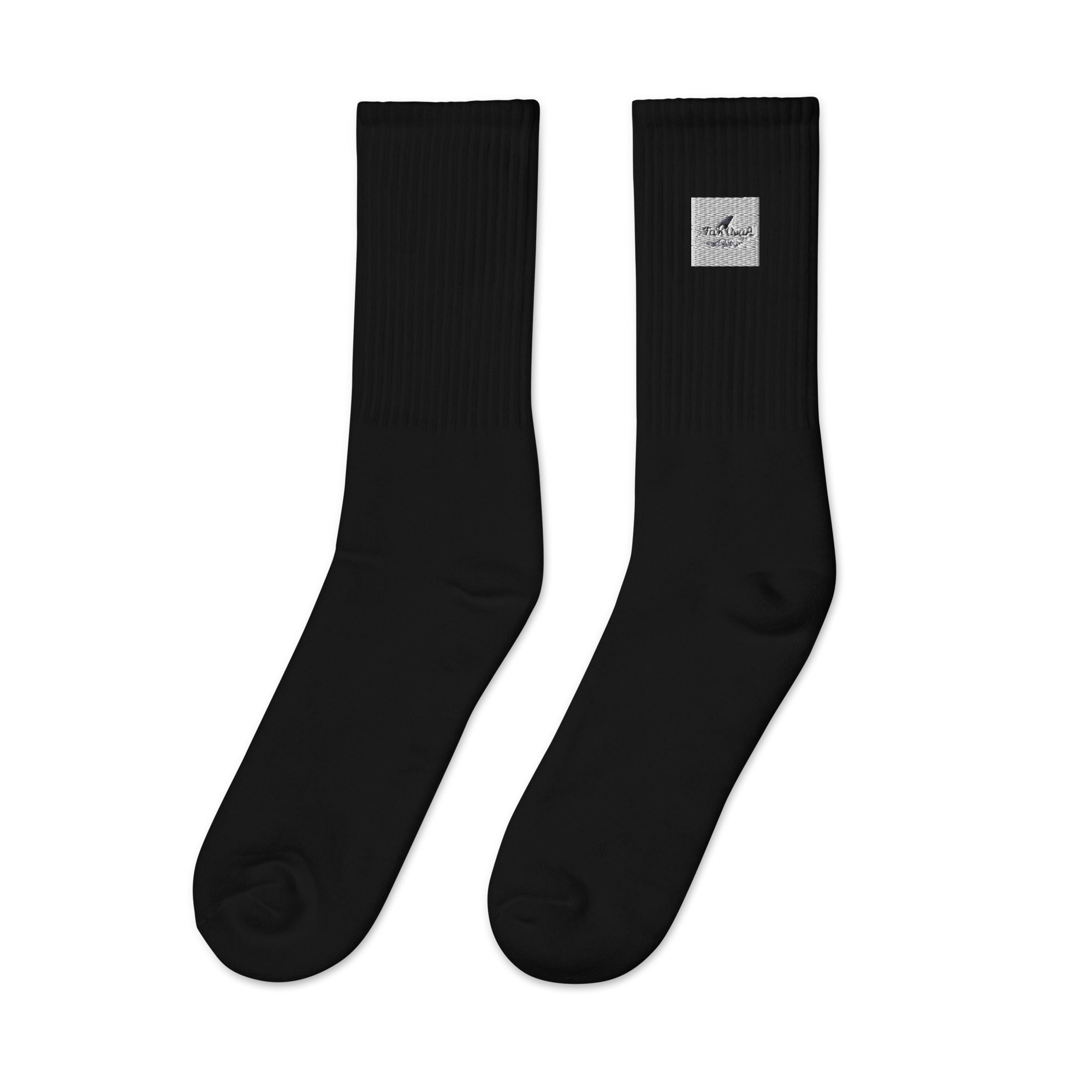 Pair of black socks with a small label on a white background