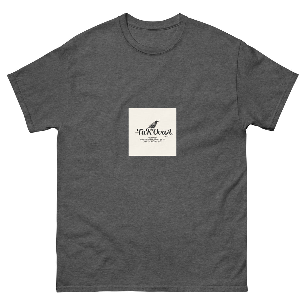 Gray t-shirt with a small white square logo featuring text and a bird illustration on a white background.