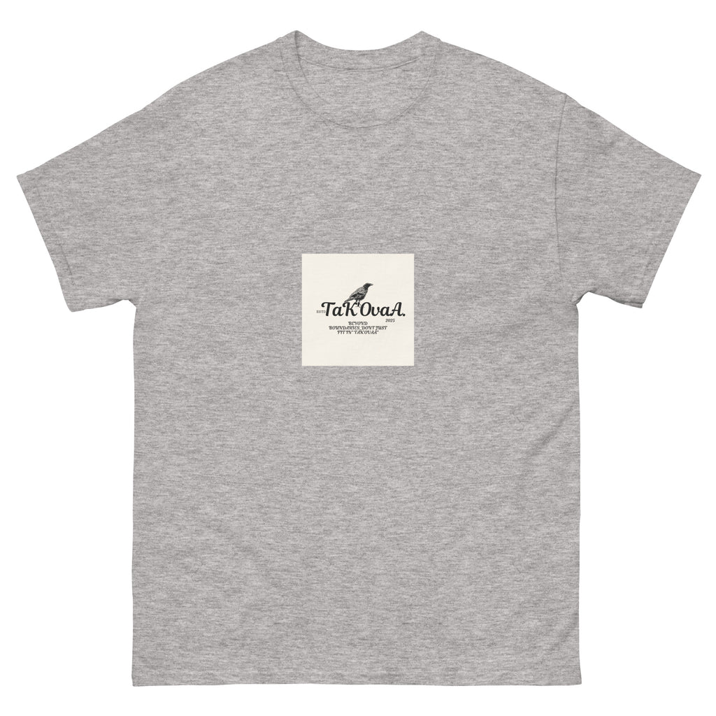 Gray t-shirt with a small white square logo featuring text and a bird illustration on a white background