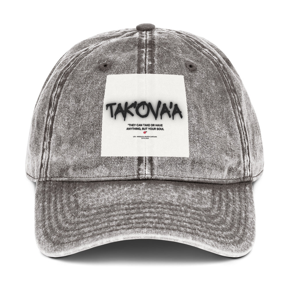 Gray denim cap with a white patch featuring text on a white background