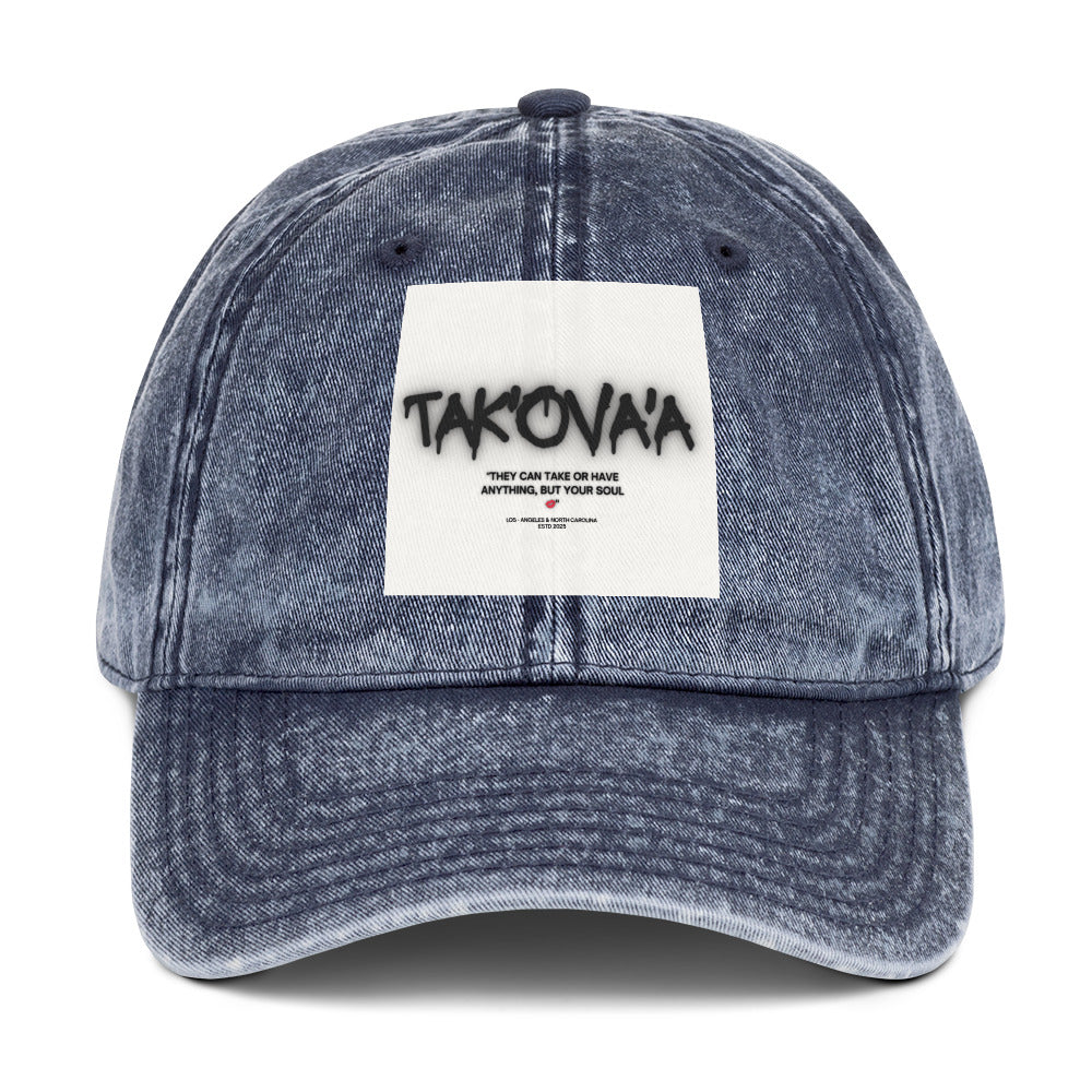 Blue denim cap with a white patch featuring text on a white background